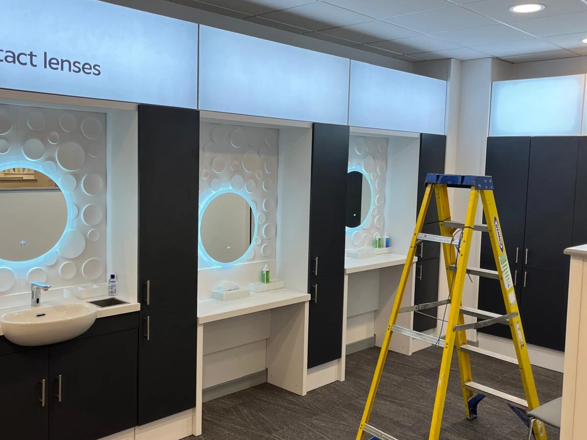 Illuminated display panels and mirror lighting fitted in an optician's contact lens area