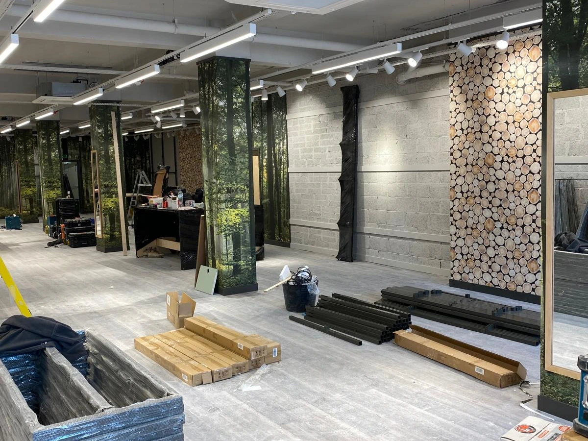 Suspended linear and track lighting during a forest-themed retail fit-out