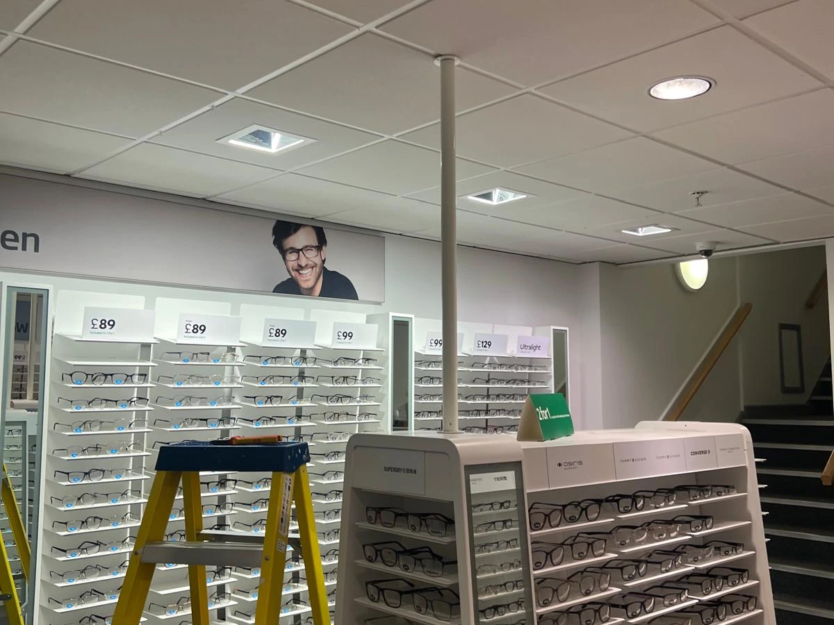 Recessed ceiling lighting installed above eyewear displays in an optician